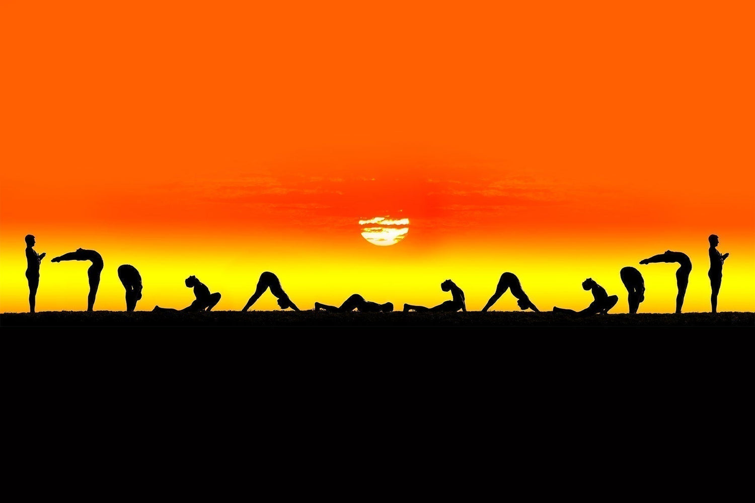 Silhouettes of people performing a full sequence of sun salutations at sunrise, set against a vivid orange and yellow sky.