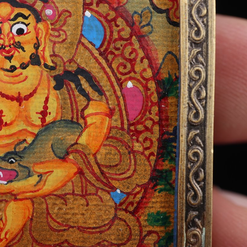 Dzambhala Thangka: Tibetan Painted Thangka Pendant - Mantrapiece.com